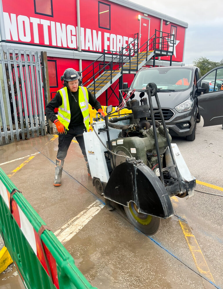 A man using a floor sawing machine