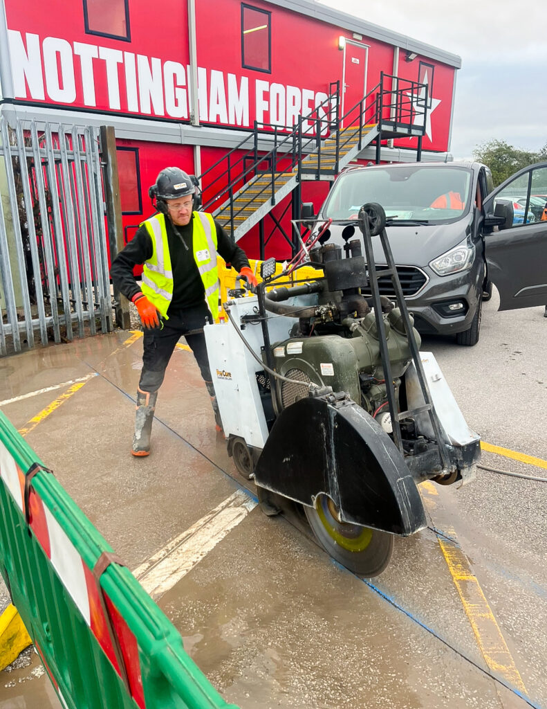 A man using a floor sawing machine